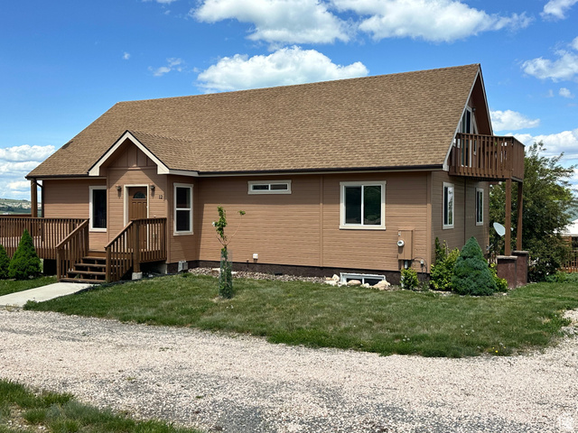 12 Crook Street Fish Haven, ID 83287 - Photo 2 of 35 View of front facade featuring a shingled roof and a front lawn