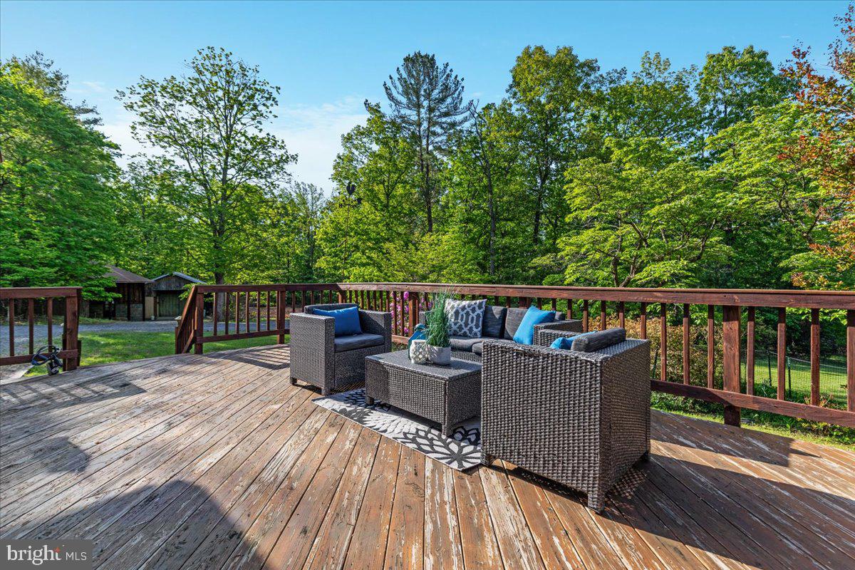 146 Lizzie Mills Road Castleton, VA 22716 - Photo 36 of 91 a view of a deck with wooden floor and furniture