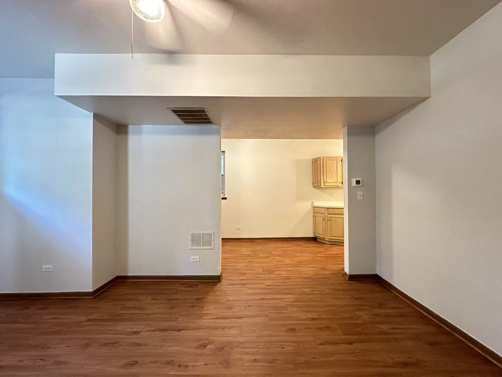 3832 North Fremont Street, Unit G Chicago, IL 60613 - Photo 12 of 20 a view of an empty room and wooden floor