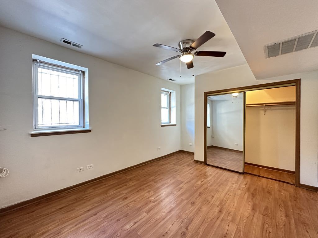 3832 North Fremont Street, Unit G Chicago, IL 60613 - Photo 16 of 20 a view of empty room with wooden floor and fan