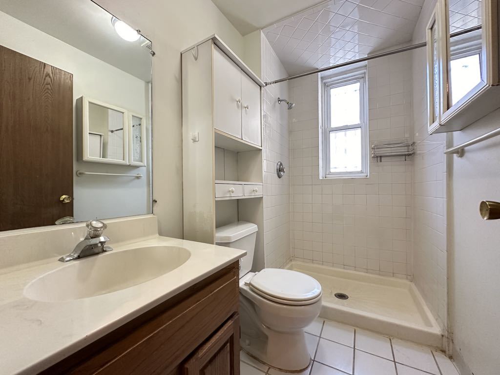 3832 North Fremont Street, Unit G Chicago, IL 60613 - Photo 19 of 20 a bathroom with a sink a toilet and shower