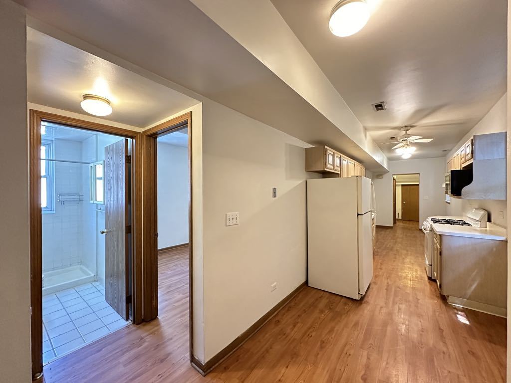 3832 North Fremont Street, Unit G Chicago, IL 60613 - Photo 9 of 20 a view of a hallway with wooden floor