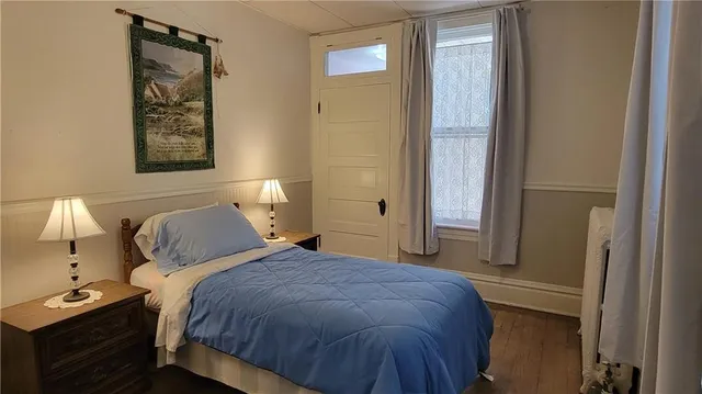 a bedroom with a bed and a chair