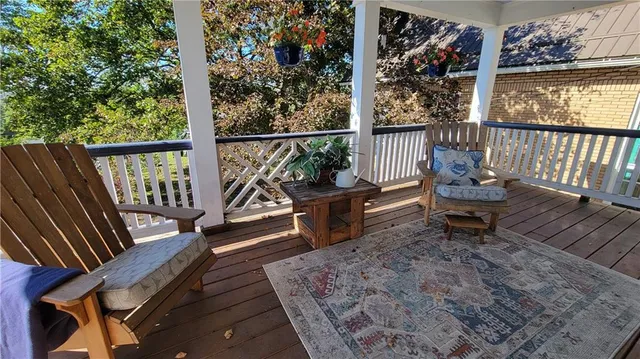 a view of a house with chairs and potted plants