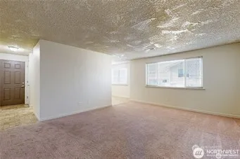 a view of an empty room and a window