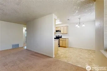 a view of a kitchen with a stove cabinets and a wooden floor