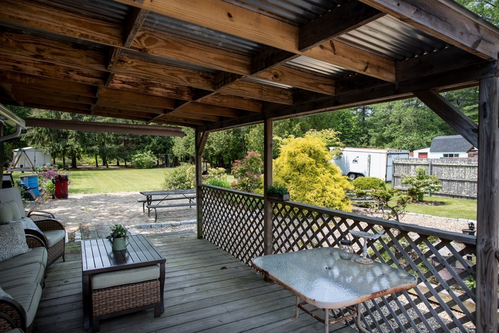 15 County Road East Freetown, MA 02717 - Photo 27 of 36 a view of a chairs and table in patio with wooden fence