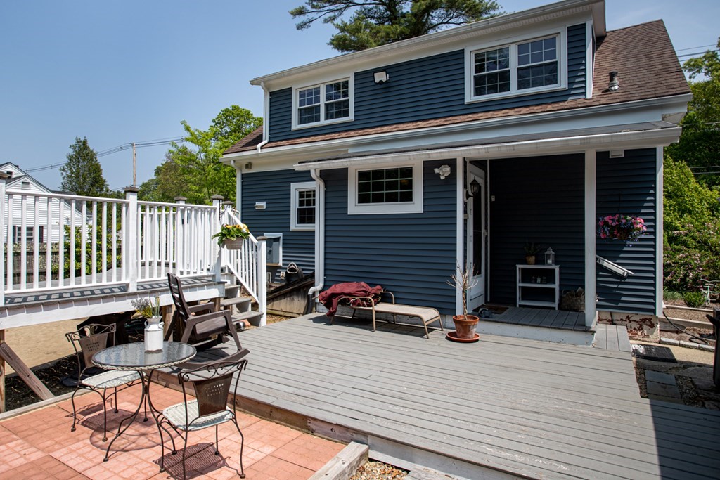 15 County Road East Freetown, MA 02717 - Photo 28 of 36 a view of a roof deck with table and chairs a barbeque with wooden floor and fence