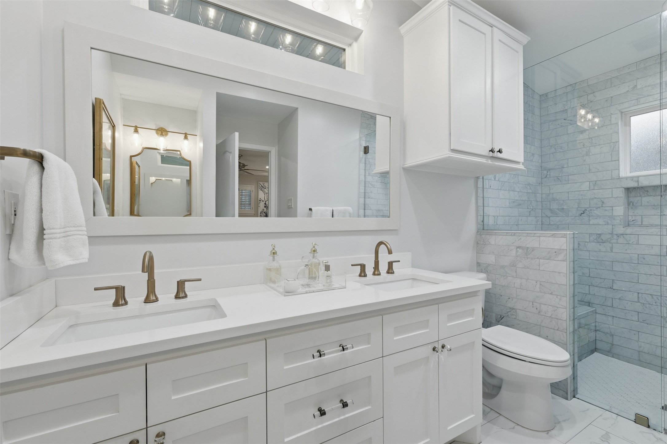 6236 Locke Lane Houston, TX 77057 - Photo 22 of 35 This primary bathroom is quite spacious with two sinks, a large walk-in shower, and a separate makeup vanity as shown in the following photo.