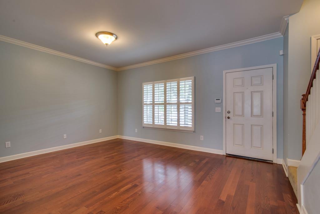 553 Rosedale Avenue, Unit 127 Nashville, TN 37211 - Photo 4 of 27 a view of an empty room with wooden floor and a window