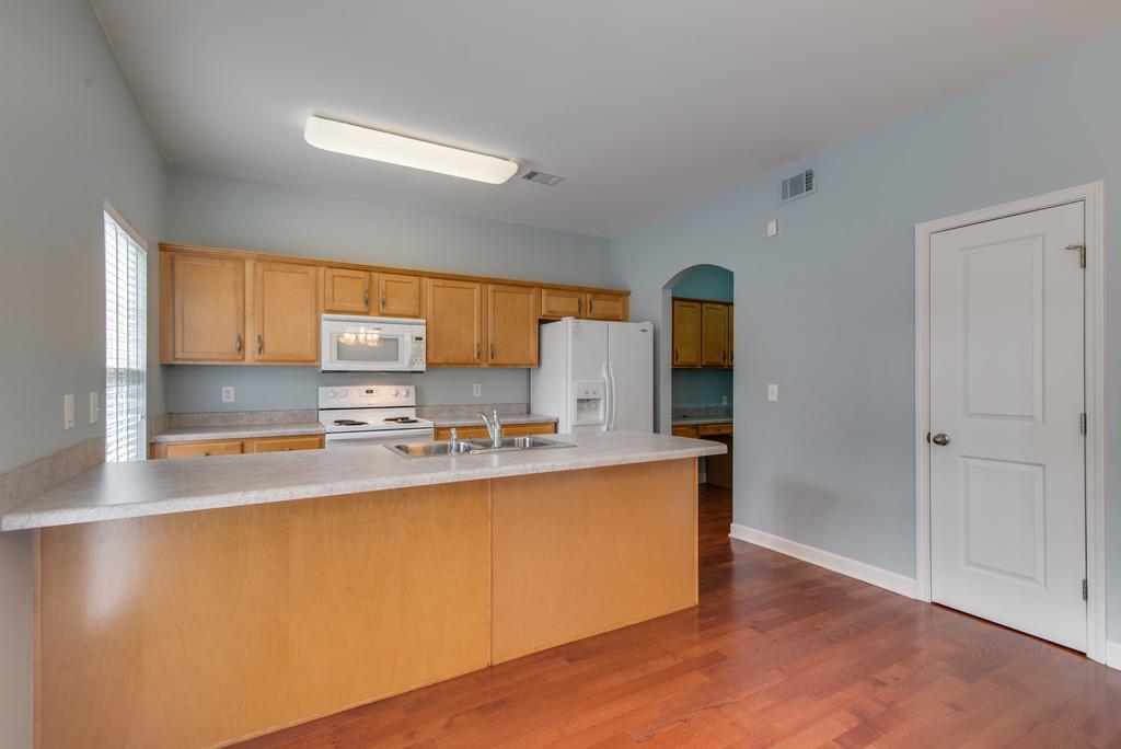 553 Rosedale Avenue, Unit 127 Nashville, TN 37211 - Photo 8 of 27 a kitchen with stainless steel appliances granite countertop a stove a sink and a refrigerator