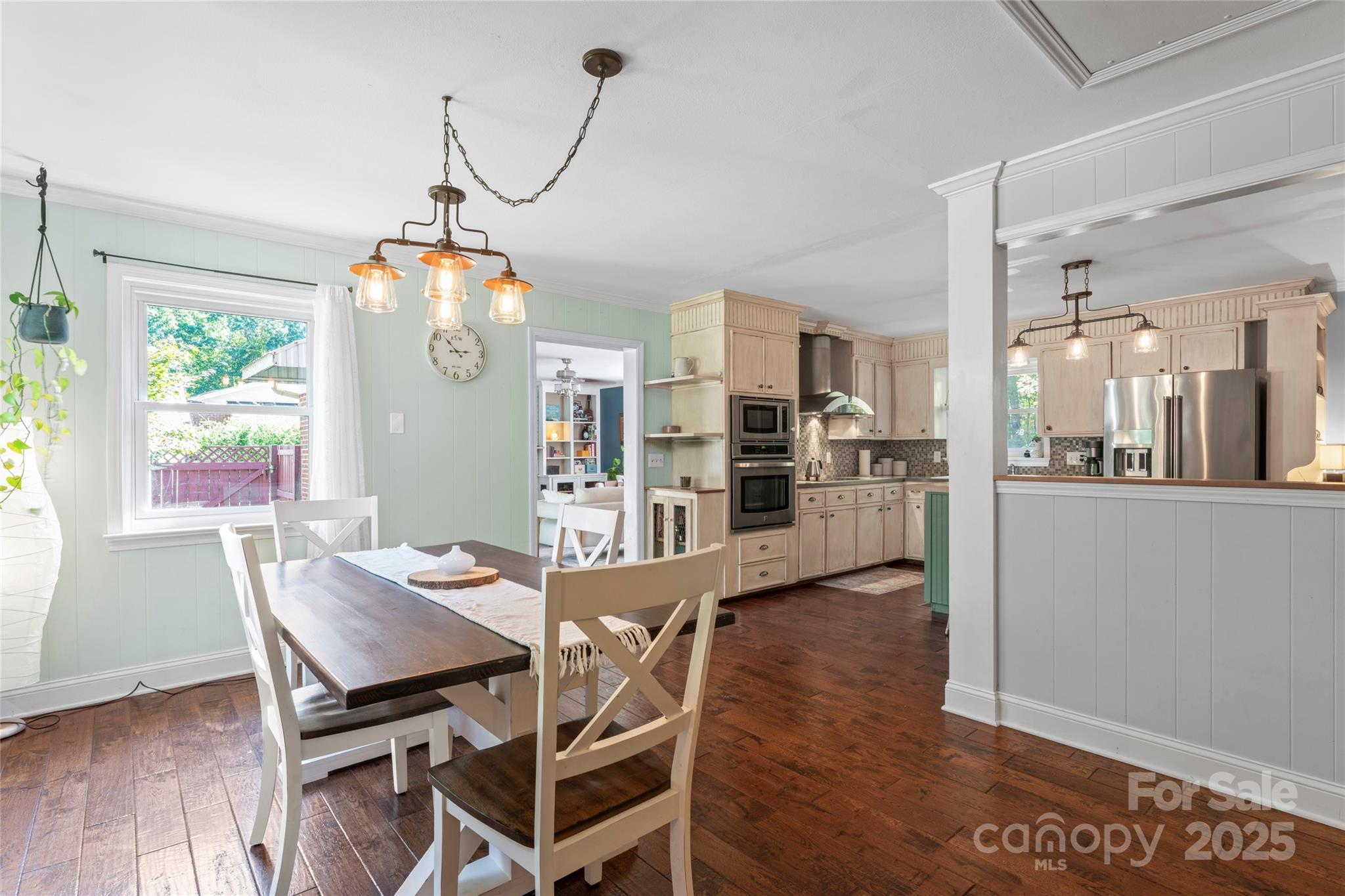 14217 Phillips Road Matthews, NC 28105 - Photo 12 of 38 a view of a dining room with furniture and wooden floor