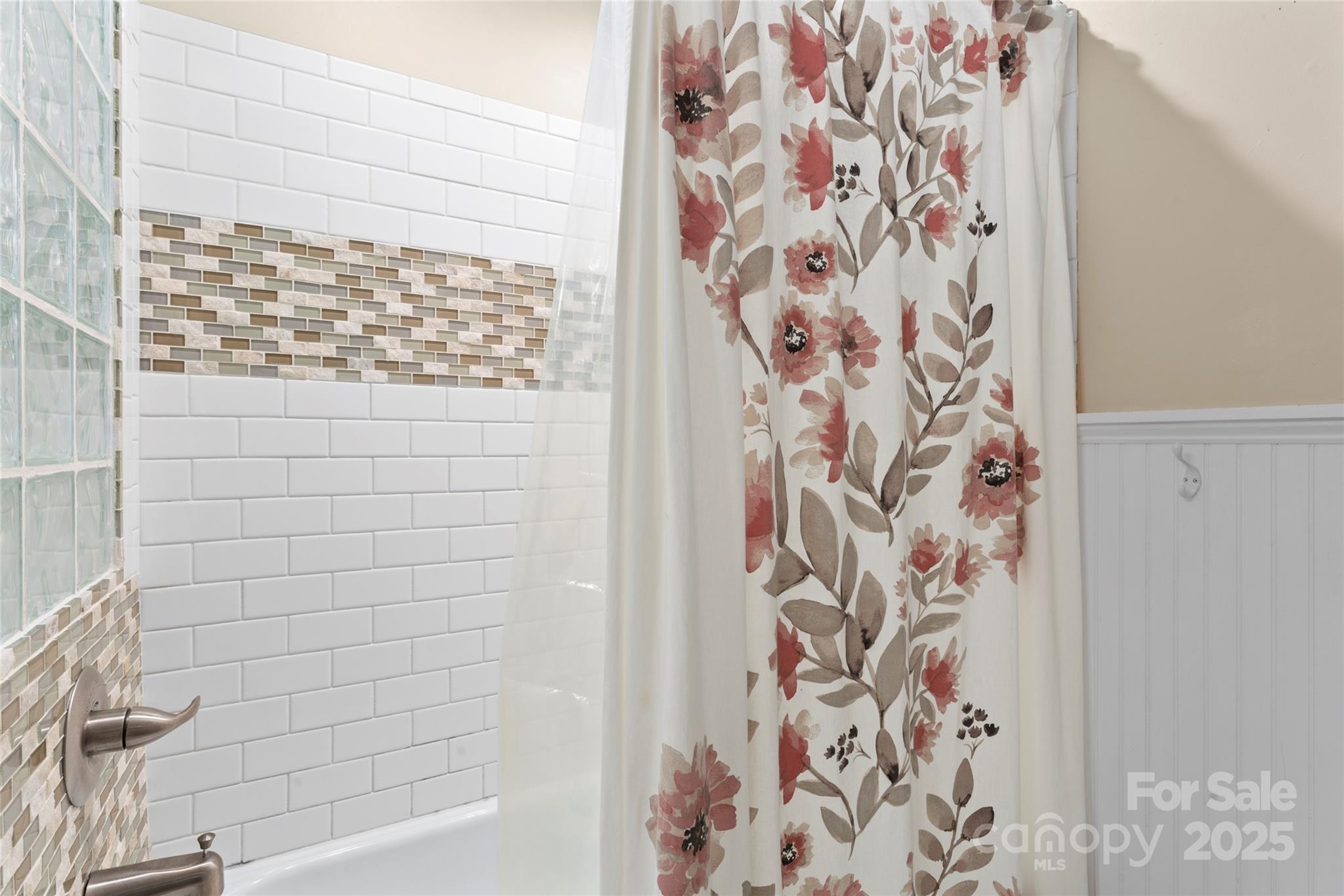 14217 Phillips Road Matthews, NC 28105 - Photo 23 of 38 a bathroom with a shower curtain