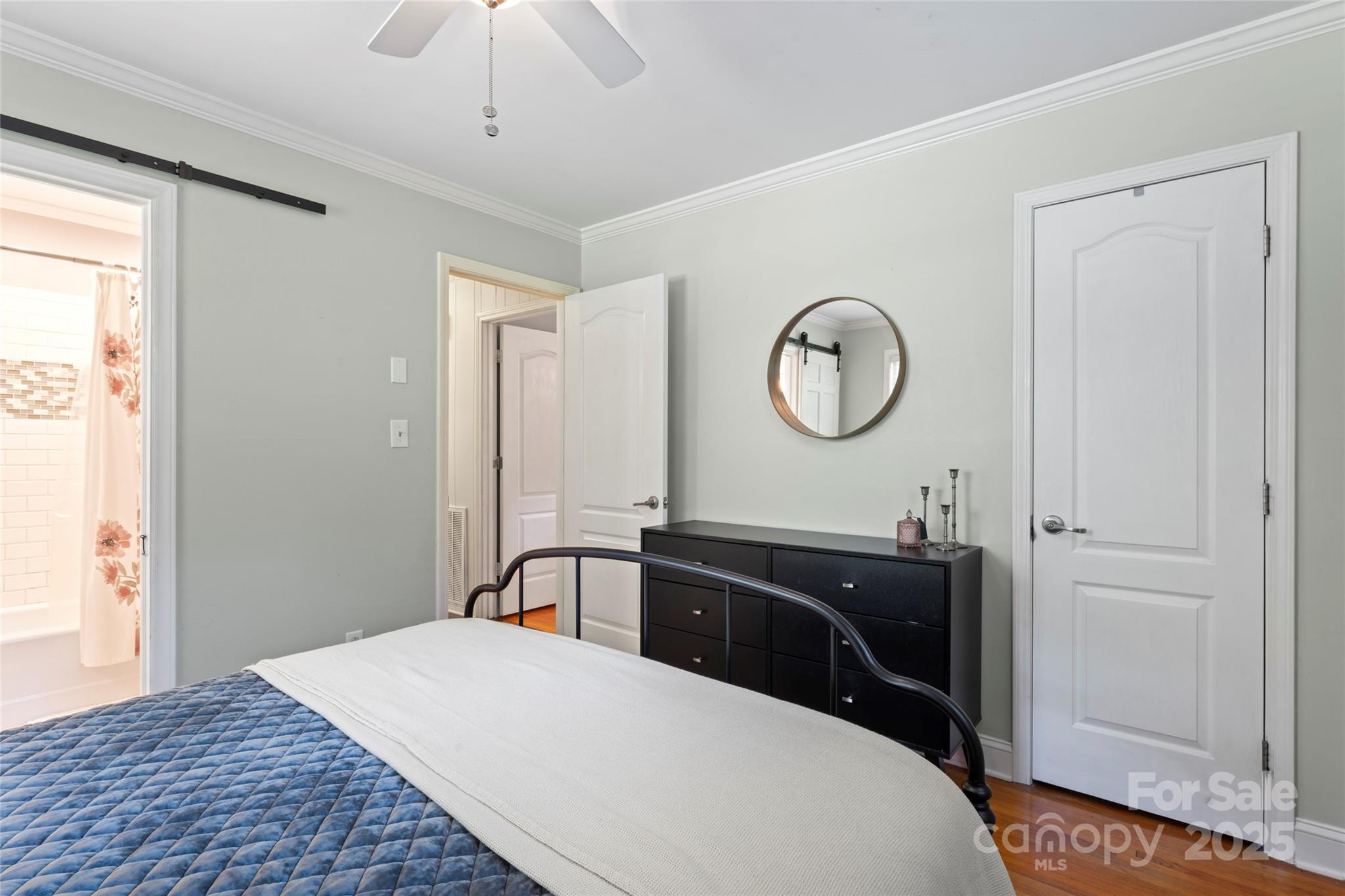 14217 Phillips Road Matthews, NC 28105 - Photo 27 of 38 a bedroom with a bed and a chandelier