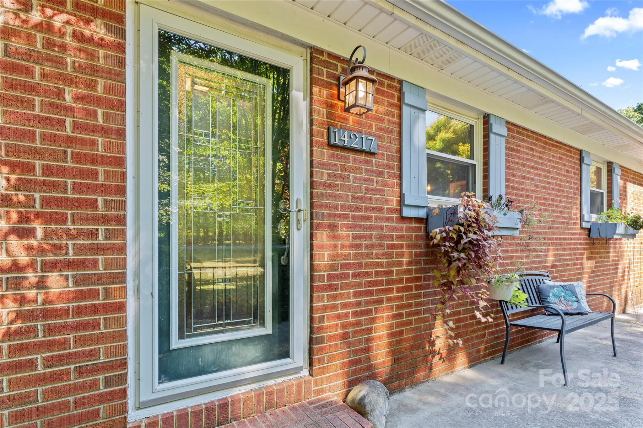 14217 Phillips Road Matthews, NC 28105 - Photo 3 of 38 a brick building with a bench and a window