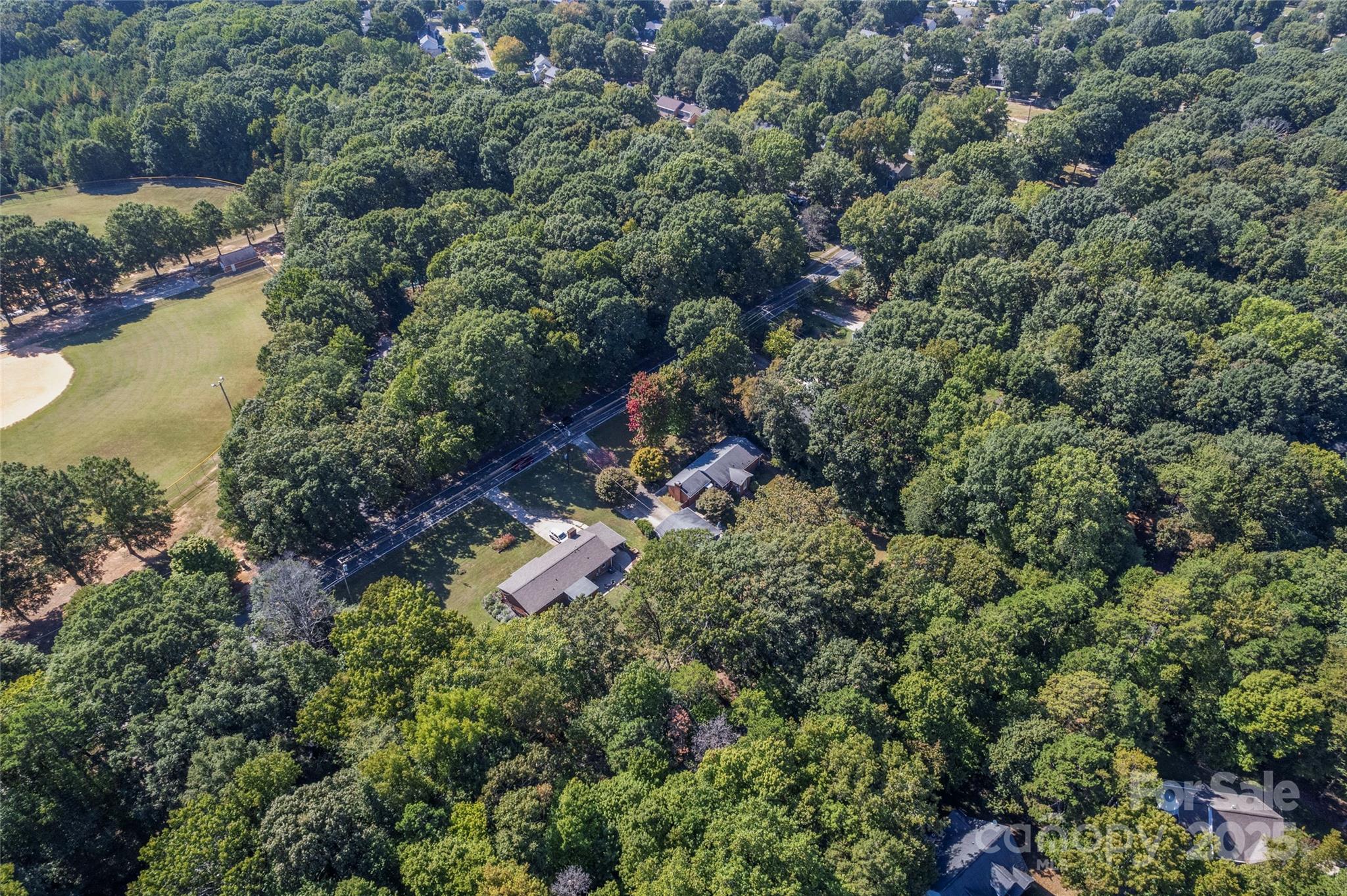 14217 Phillips Road Matthews, NC 28105 - Photo 34 of 38 an aerial view of a house with a yard and lake view