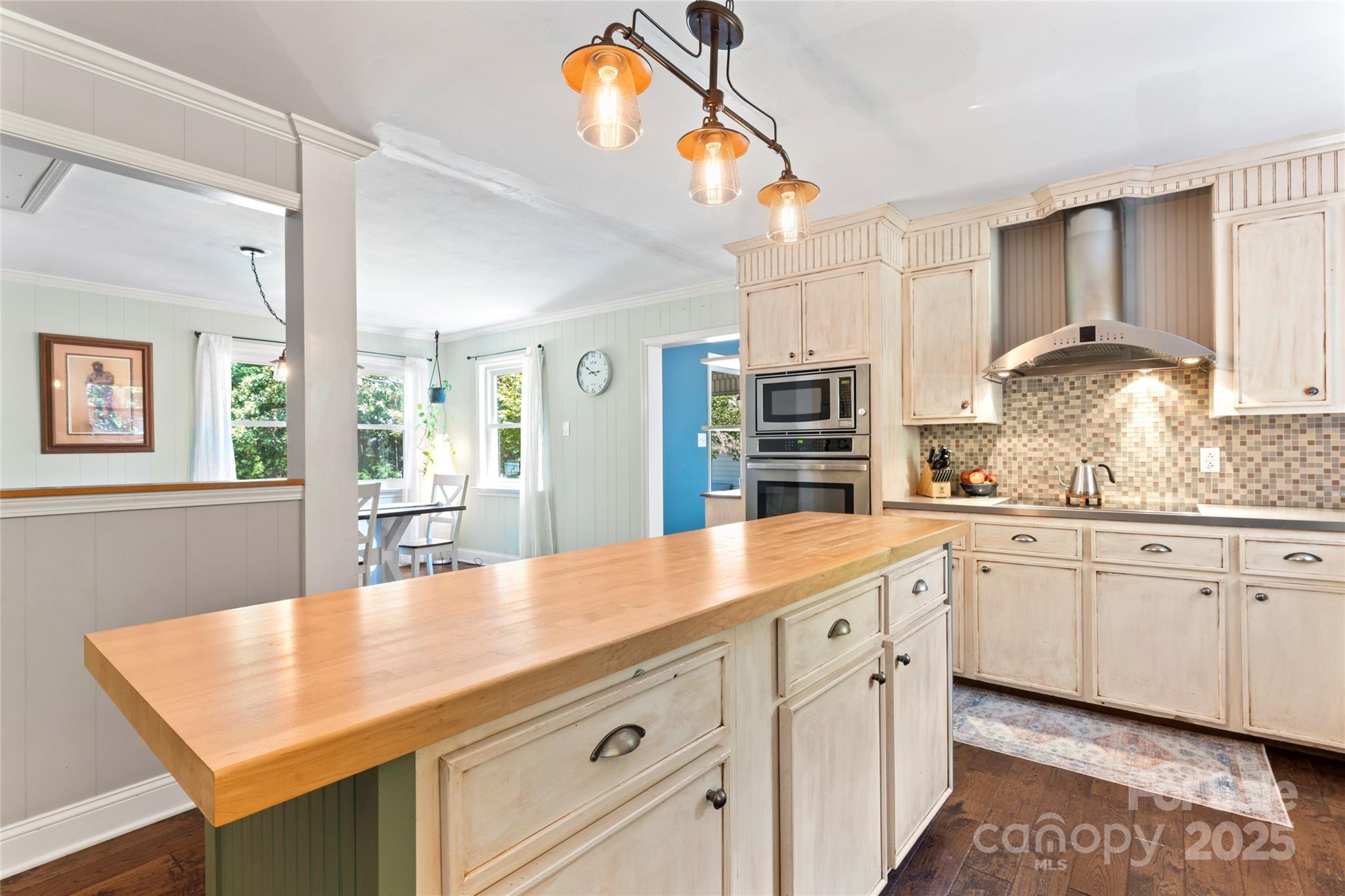 14217 Phillips Road Matthews, NC 28105 - Photo 7 of 38 a kitchen with stainless steel appliances granite countertop a sink and dishwasher with white cabinets