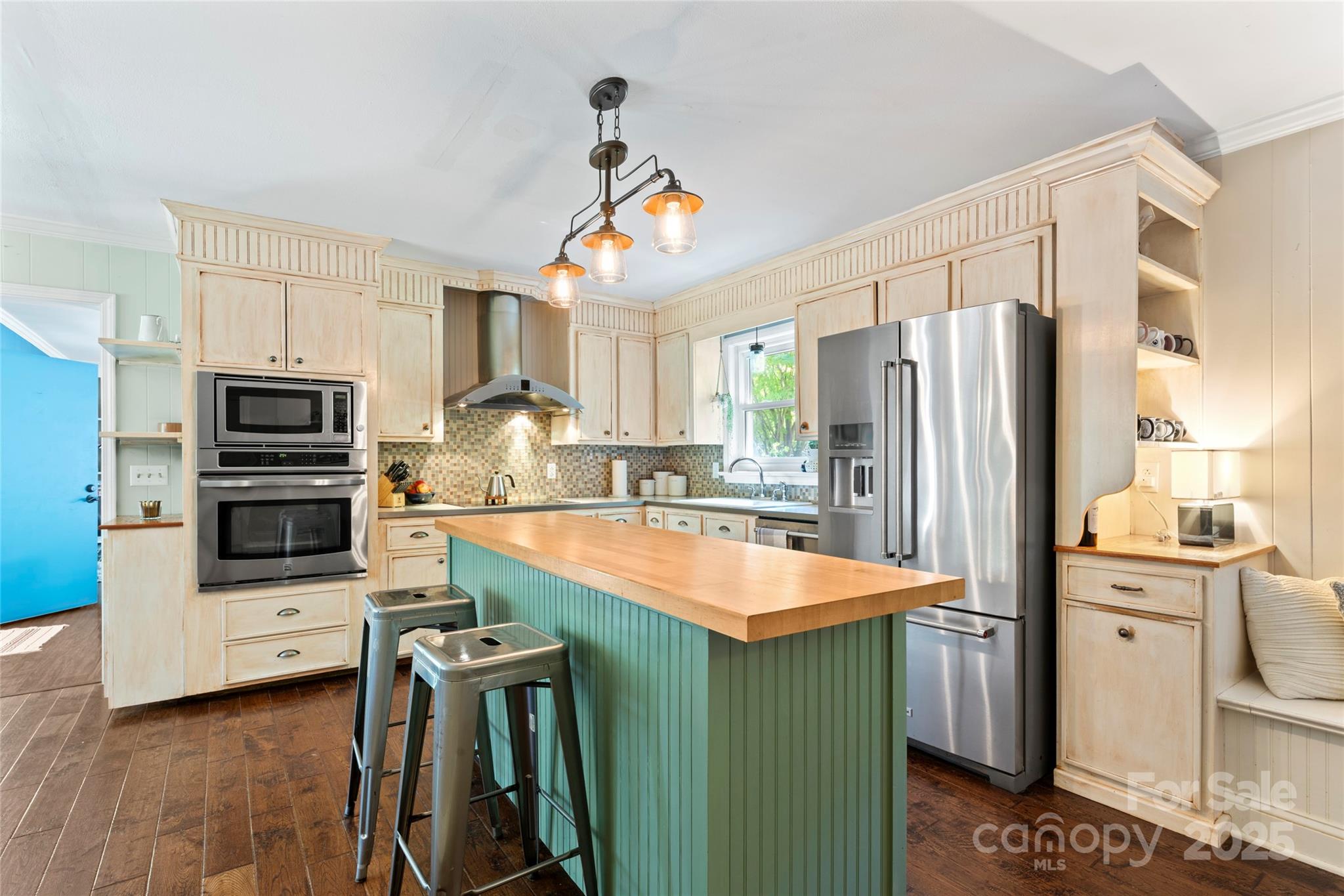 14217 Phillips Road Matthews, NC 28105 - Photo 8 of 38 a kitchen with stainless steel appliances kitchen island granite countertop a refrigerator a stove and a sink