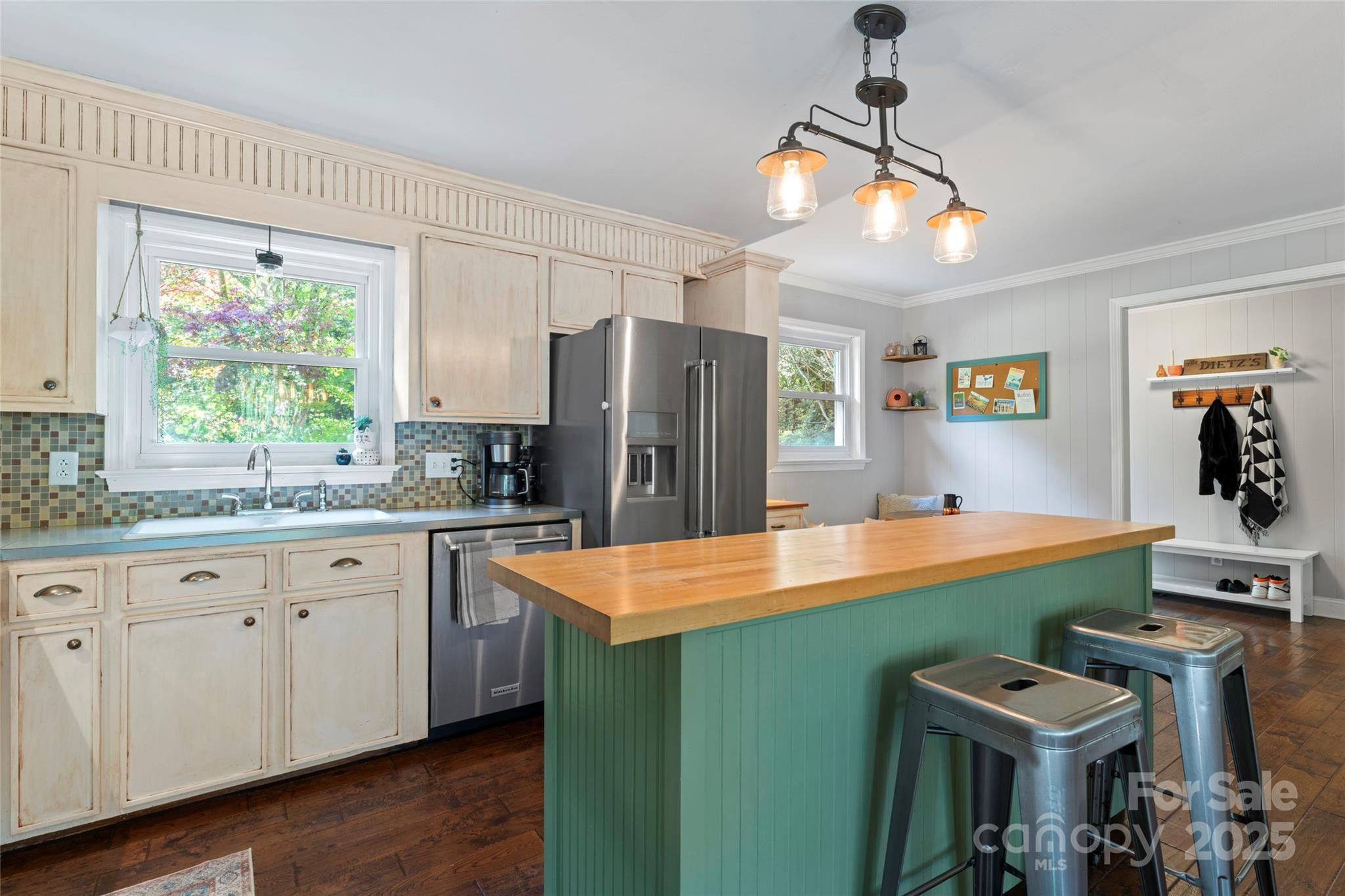 14217 Phillips Road Matthews, NC 28105 - Photo 9 of 38 a kitchen with kitchen island stainless steel appliances a sink stove and refrigerator