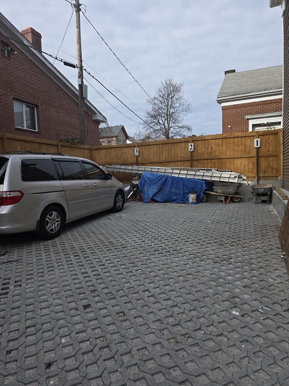 475 Purchase Street, Unit 3 New Bedford, MA 02740 - Photo 5 of 20 a couple of cars parked in parking area of a building