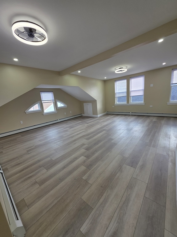 475 Purchase Street, Unit 3 New Bedford, MA 02740 - Photo 7 of 20 an empty room with wooden floor and windows