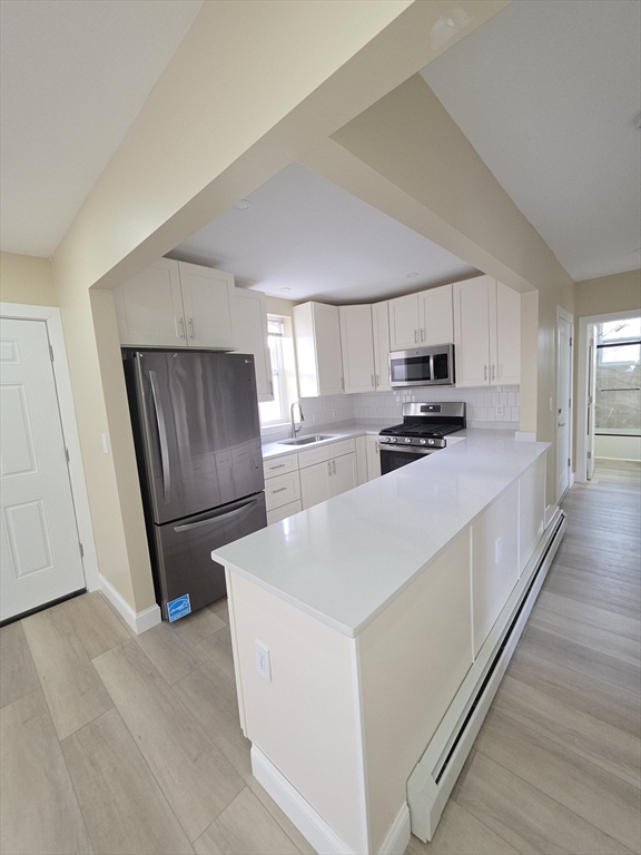 475 Purchase Street, Unit 3 New Bedford, MA 02740 - Photo 9 of 20 a kitchen with stainless steel appliances a refrigerator sink and microwave