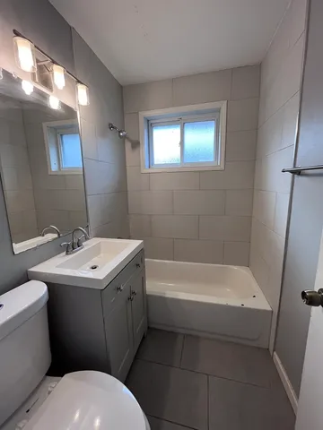 a bathroom with a sink a toilet and bathtub