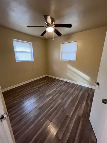 a view of room with window and ceiling fan