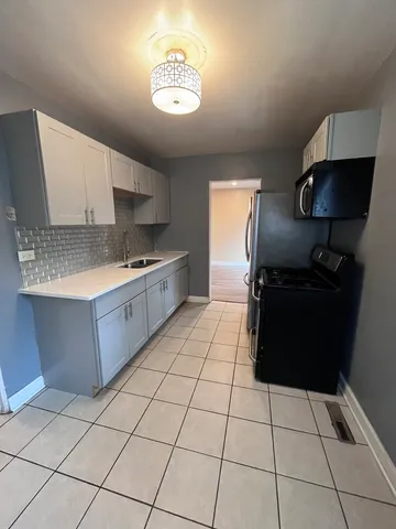 a kitchen with stainless steel appliances a sink a stove a microwave and cabinets