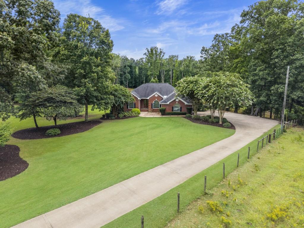 300 Potts Lane Covington, GA 30016 - Photo 1 of 76 a view of a garden with a building in the background