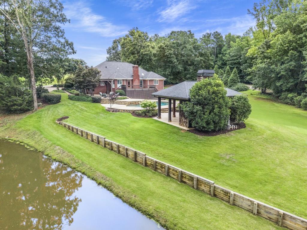 300 Potts Lane Covington, GA 30016 - Photo 11 of 76 a aerial view of a house with a garden and a swimming pool