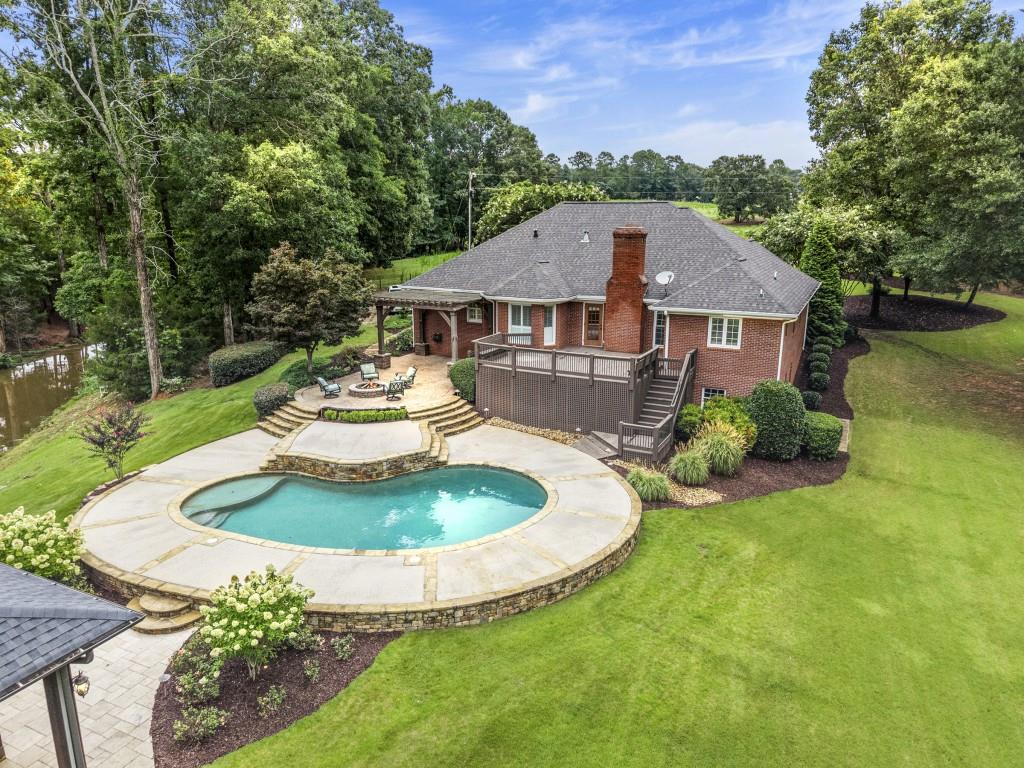 300 Potts Lane Covington, GA 30016 - Photo 12 of 76 a view of a house with a yard fire pit and a patio