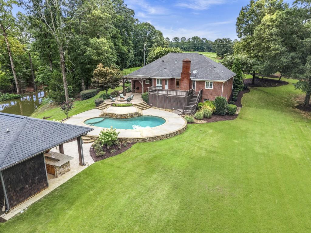300 Potts Lane Covington, GA 30016 - Photo 13 of 76 a aerial view of a house with swimming pool and a yard