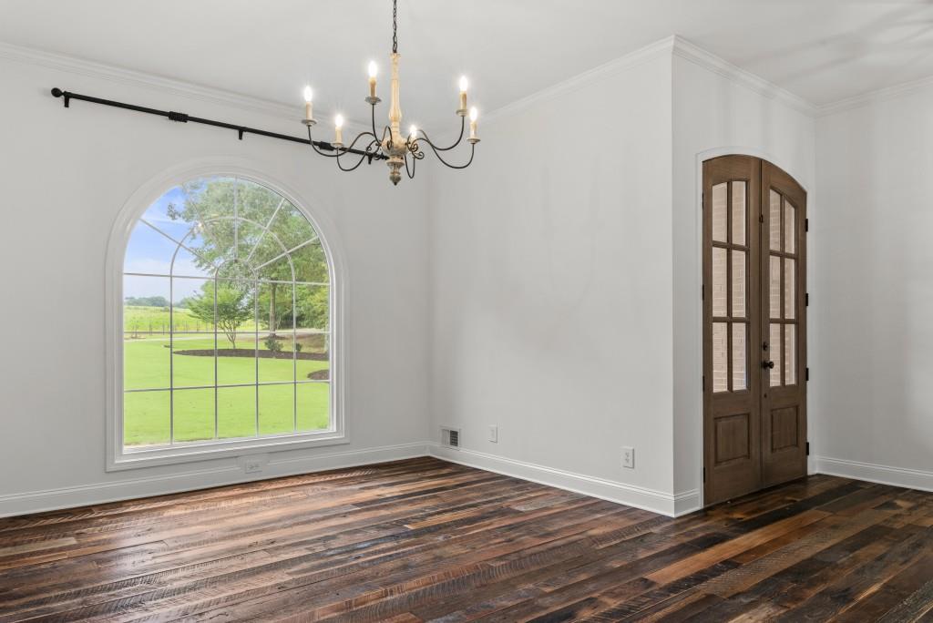 300 Potts Lane Covington, GA 30016 - Photo 19 of 76 a view of a room with wooden floor chandelier and windows