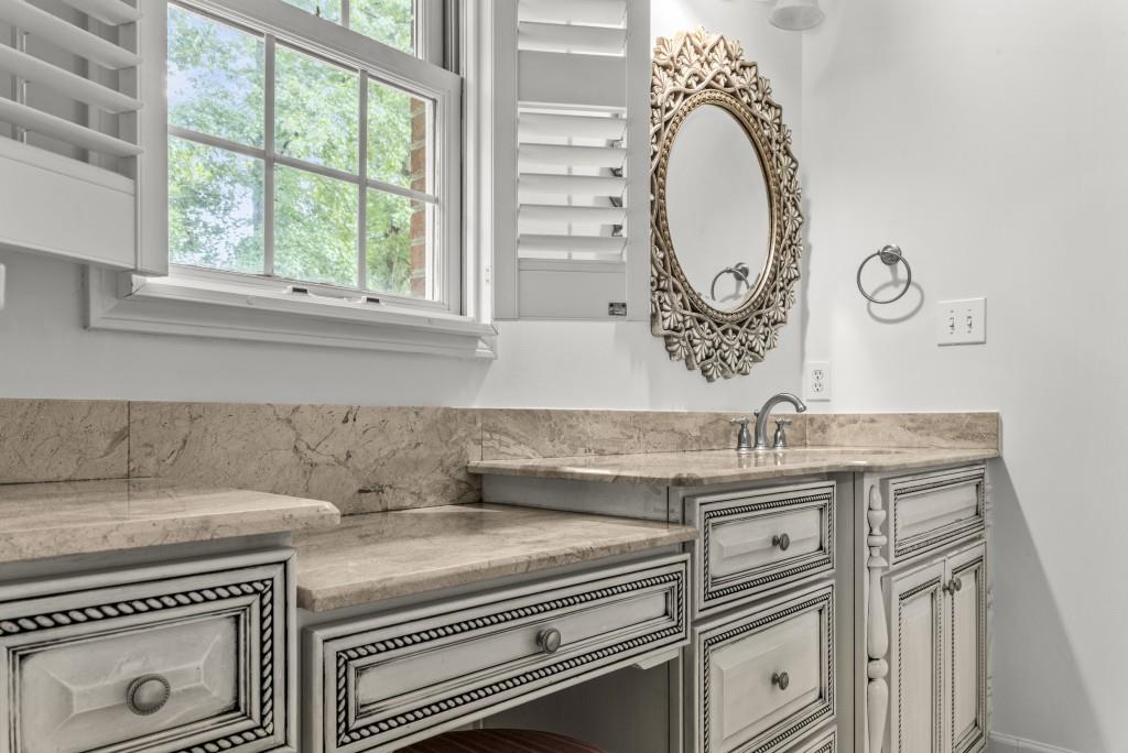 300 Potts Lane Covington, GA 30016 - Photo 28 of 76 a kitchen with a stove and a white wooden cabinets