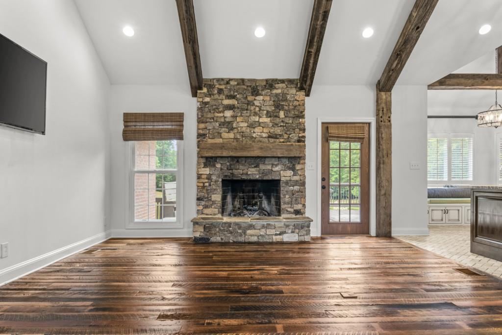 300 Potts Lane Covington, GA 30016 - Photo 29 of 76 a view of a livingroom with a fireplace wooden floor and windows