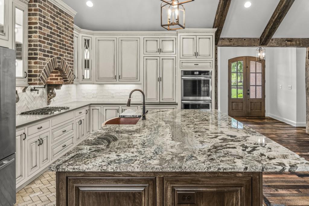 300 Potts Lane Covington, GA 30016 - Photo 34 of 76 a kitchen with stainless steel appliances granite countertop a stove and cabinets