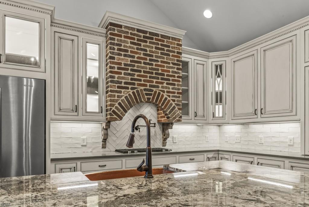 300 Potts Lane Covington, GA 30016 - Photo 37 of 76 a kitchen with granite countertop a sink and a stove