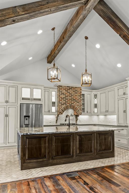 300 Potts Lane Covington, GA 30016 - Photo 38 of 76 a large kitchen with stainless steel appliances kitchen island granite countertop a refrigerator and a stove top oven