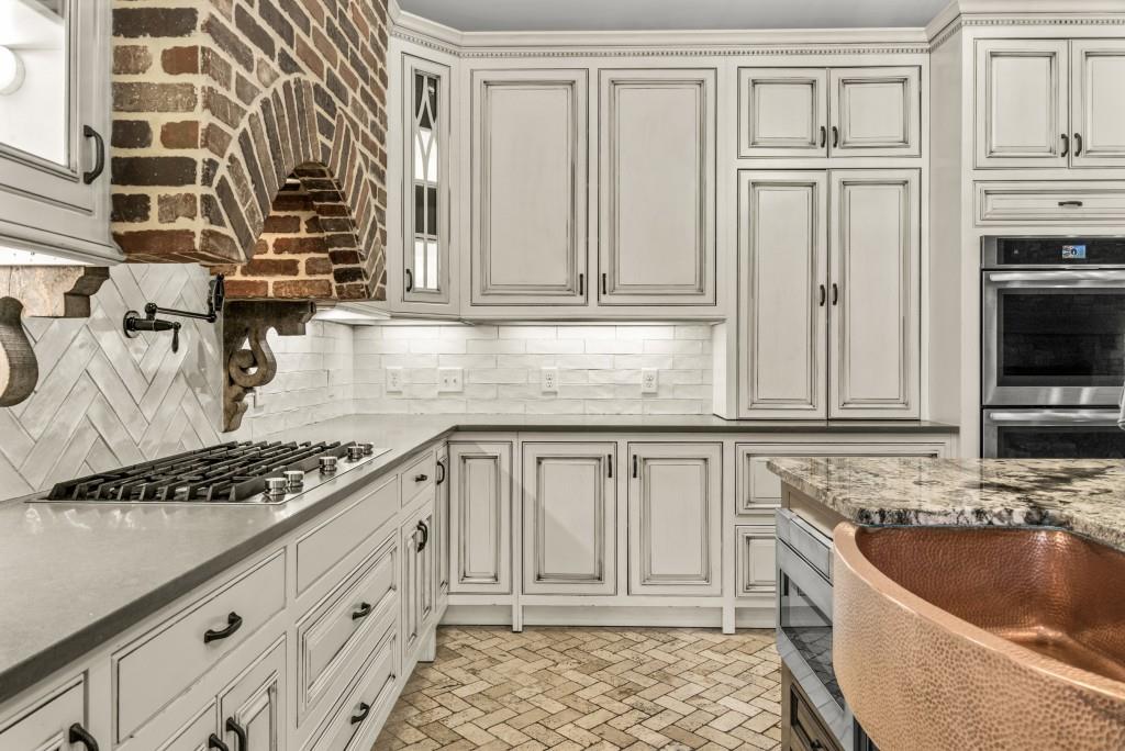 300 Potts Lane Covington, GA 30016 - Photo 40 of 76 a kitchen with stainless steel appliances granite countertop a sink stove and cabinets
