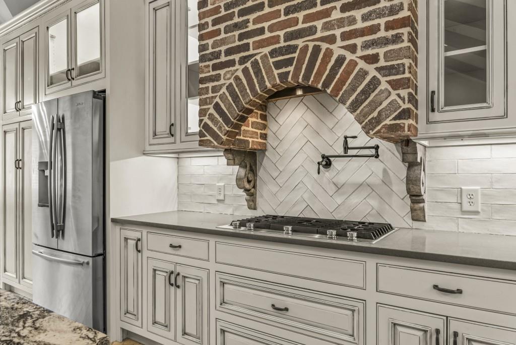300 Potts Lane Covington, GA 30016 - Photo 43 of 76 a close view of a refrigerator in kitchen and granite counter top