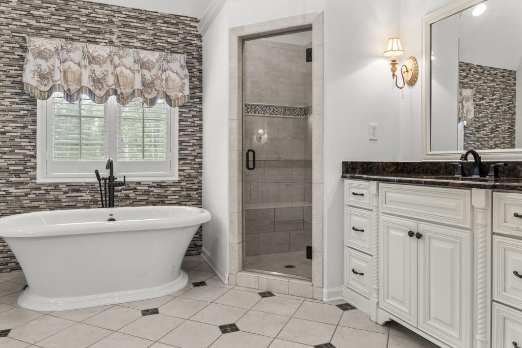300 Potts Lane Covington, GA 30016 - Photo 49 of 76 a bathroom with a bathtub and a shower