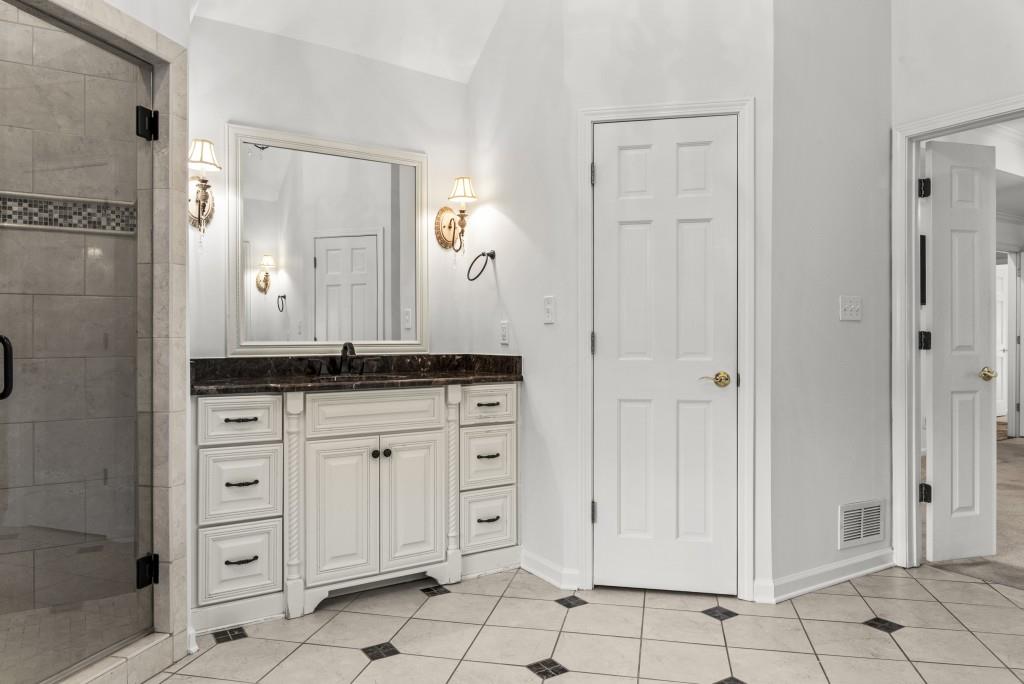 300 Potts Lane Covington, GA 30016 - Photo 51 of 76 a bathroom with white cabinets and sink