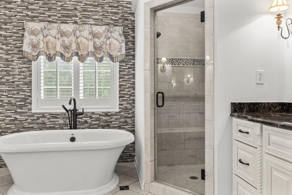 300 Potts Lane Covington, GA 30016 - Photo 52 of 76 a bathroom with a bathtub and a shower