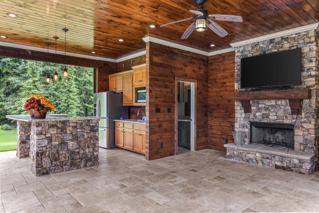 300 Potts Lane Covington, GA 30016 - Photo 65 of 76 a living room with furniture a flat screen tv and a fireplace
