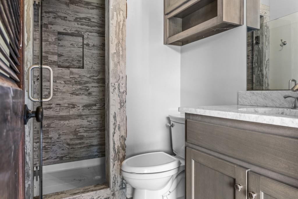 300 Potts Lane Covington, GA 30016 - Photo 68 of 76 a bathroom with a granite countertop toilet sink and shower