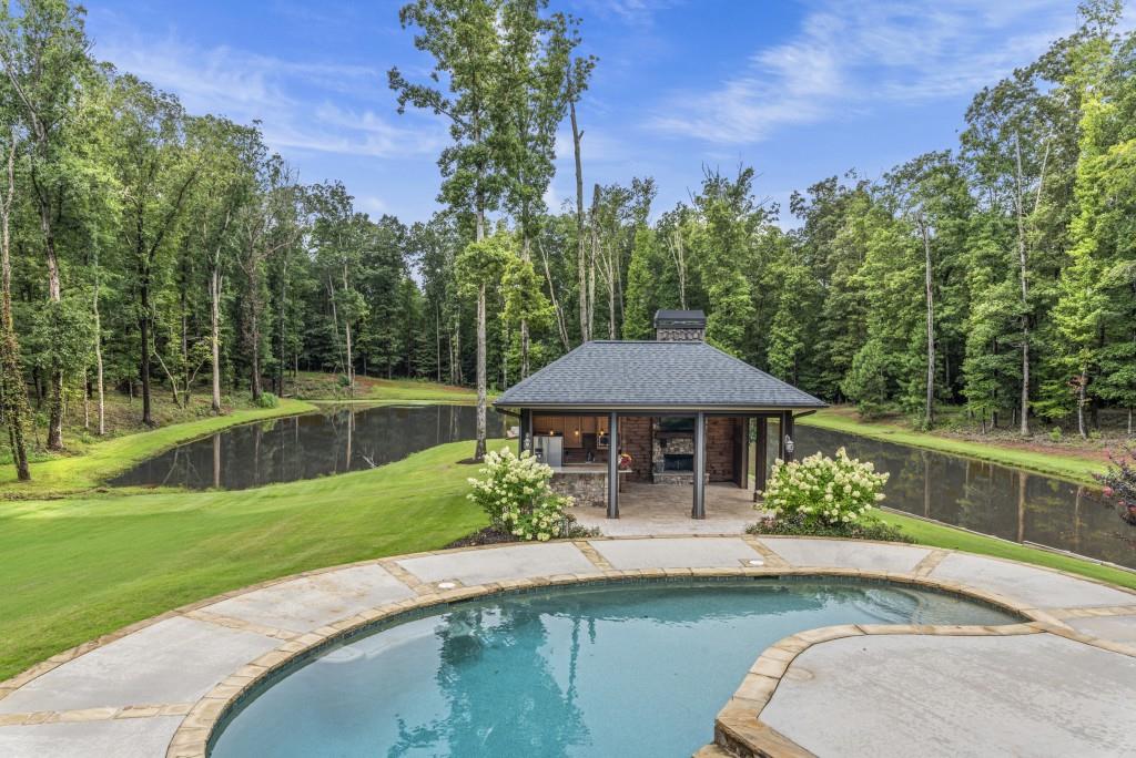 300 Potts Lane Covington, GA 30016 - Photo 75 of 76 a swimming pool with outdoor seating and yard
