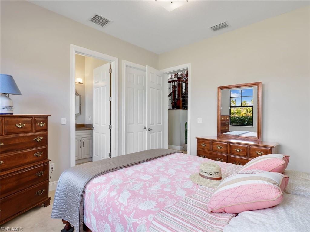 3160 27th Avenue Southwest Naples, FL 34117 - Photo 23 of 43 a bedroom with a bed and a dresser