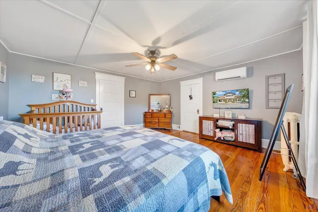a spacious bedroom with a bed and a chandelier