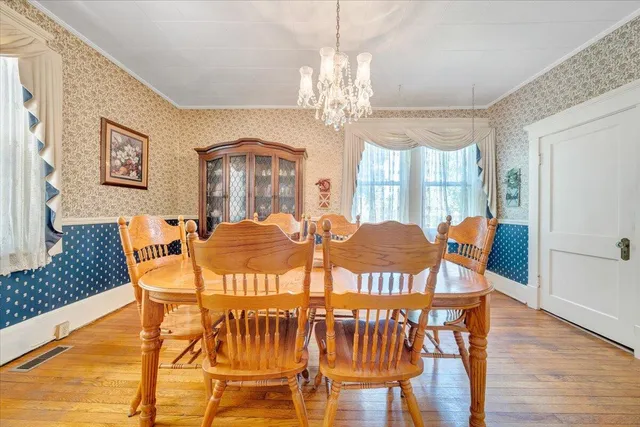 a view of a dining room with furniture wooden floor and chandelier